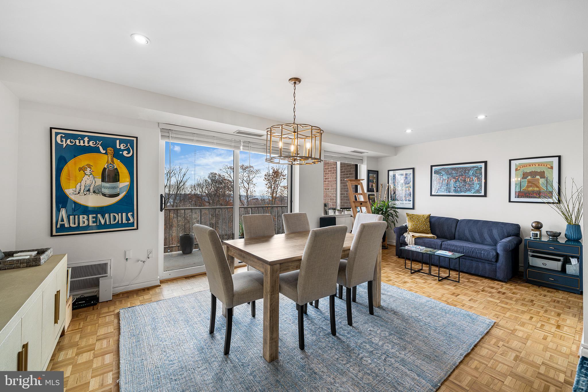 1655 Oakwood Drive, Unit N420 Narberth, PA 19072 - Photo 12 of 36 a dining room with furniture a rug a rug and a chandelier
