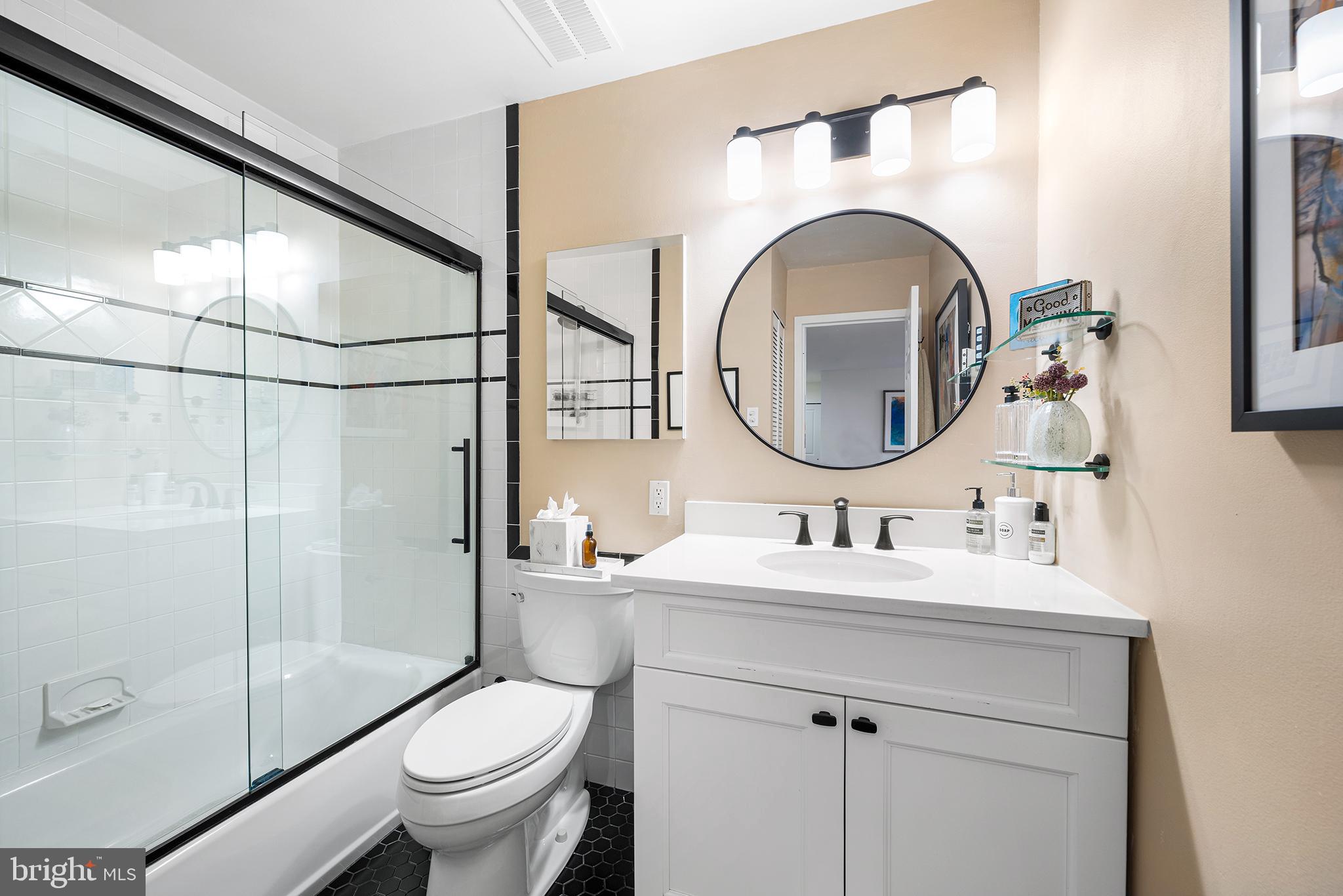 1655 Oakwood Drive, Unit N420 Narberth, PA 19072 - Photo 28 of 36 a bathroom with a sink mirror toilet and shower