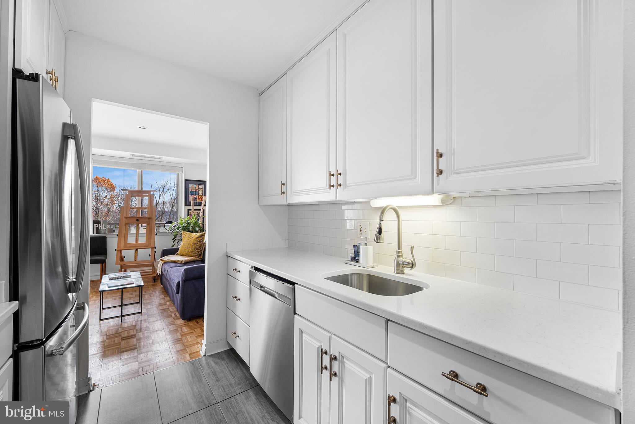 1655 Oakwood Drive, Unit N420 Narberth, PA 19072 - Photo 3 of 36 a kitchen with stainless steel appliances white cabinets and a sink