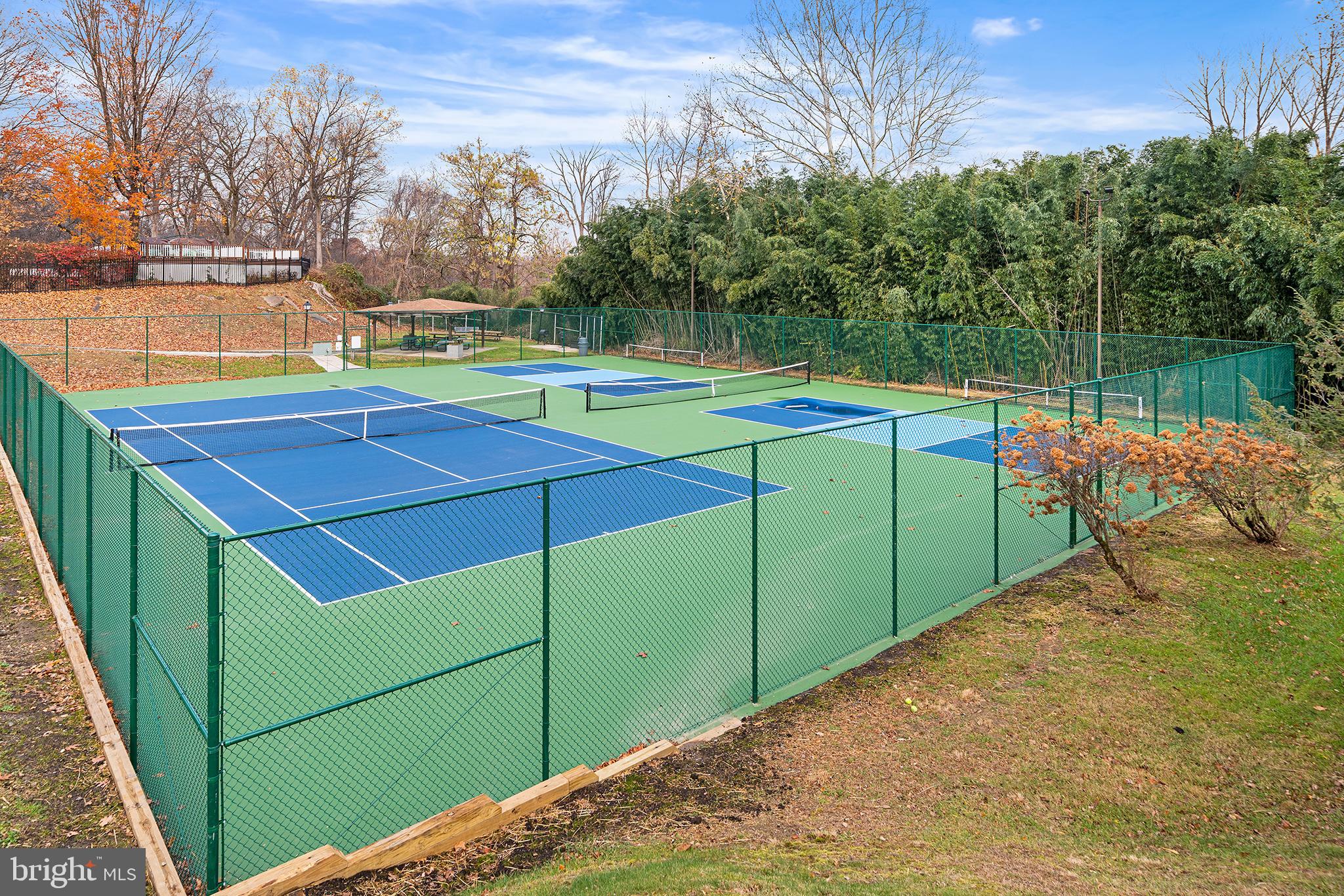 1655 Oakwood Drive, Unit N420 Narberth, PA 19072 - Photo 34 of 36 a view of a tennis ground with large trees