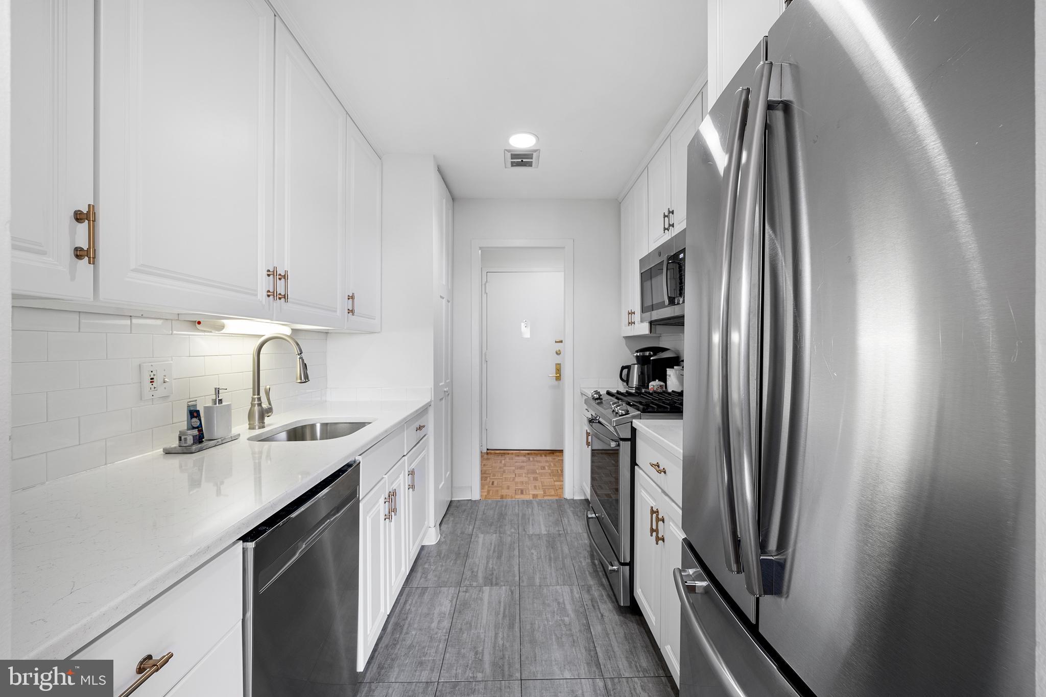 1655 Oakwood Drive, Unit N420 Narberth, PA 19072 - Photo 4 of 36 a kitchen with stainless steel appliances granite countertop a refrigerator and a sink