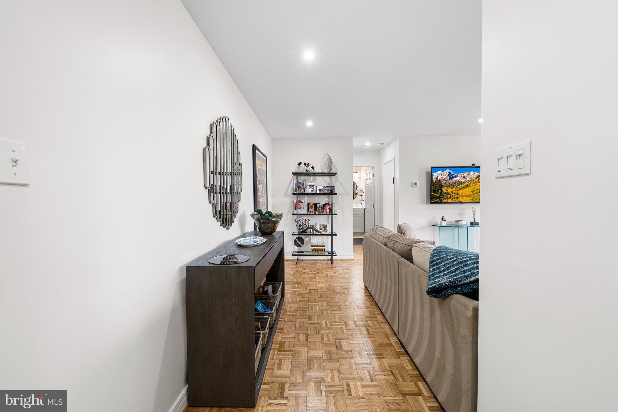 1655 Oakwood Drive, Unit N420 Narberth, PA 19072 - Photo 6 of 36 a hallway with a large mirror and a refrigerator