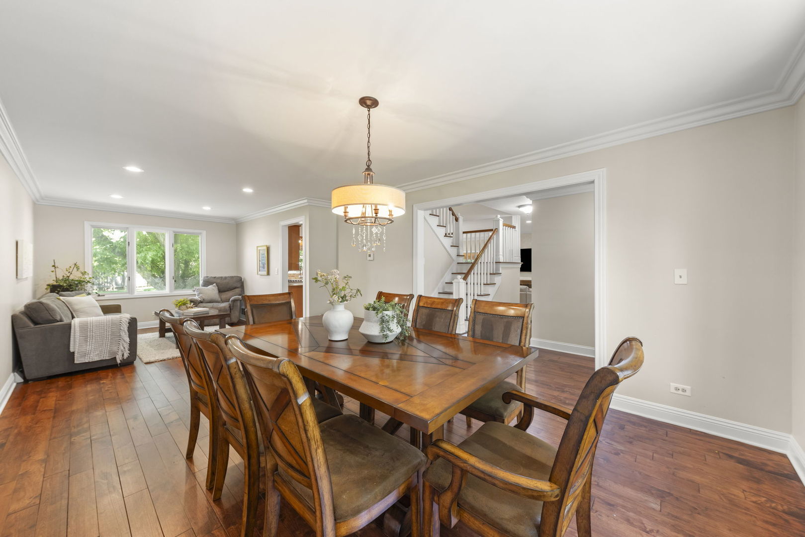 389 Pearson Circle Naperville, IL 60563 - Photo 11 of 41 a view of a dining room and livingroom with furniture wooden floor a rug a chandelier and a mirror