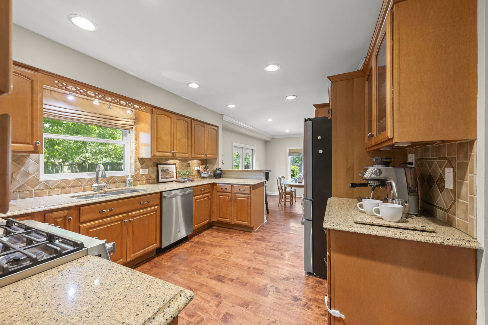389 Pearson Circle Naperville, IL 60563 - Photo 10 of 41 a kitchen with stainless steel appliances granite countertop sink stove top oven and cabinets