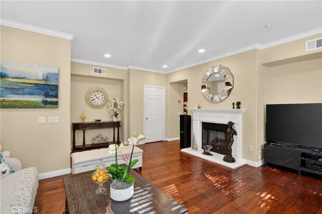 a dining room with furniture a chandelier and wooden floor