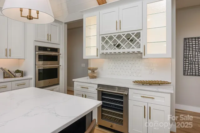 a kitchen with stainless steel appliances a stove a sink and a refrigerator