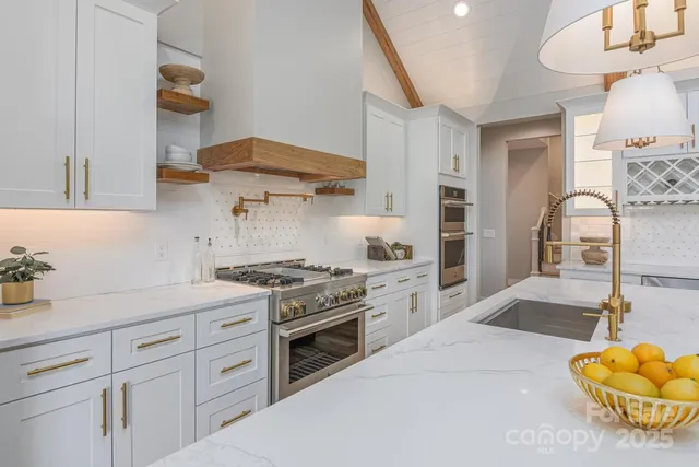 a kitchen with a stove and a white cabinets