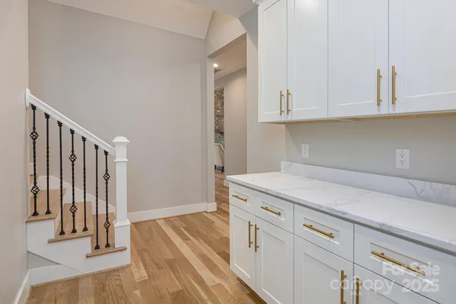 a kitchen with stainless steel appliances a stove a sink a counter space and a window