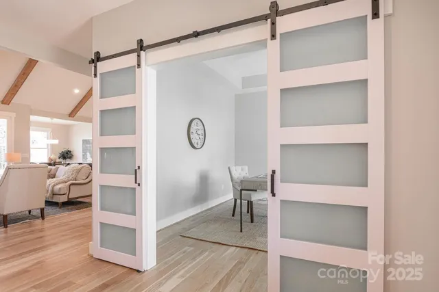 a living room with lots of furniture and kitchen view
