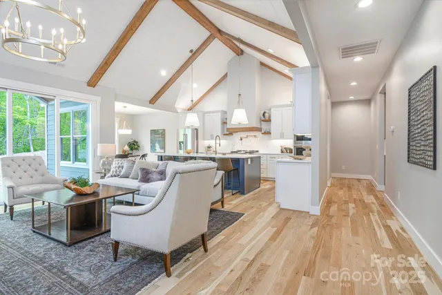 a large kitchen with kitchen island granite countertop a large counter top space a sink stainless steel appliances and cabinets