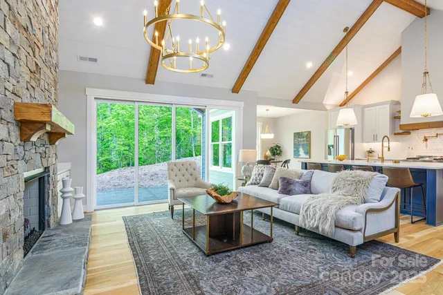 a living room with furniture tv and large windows