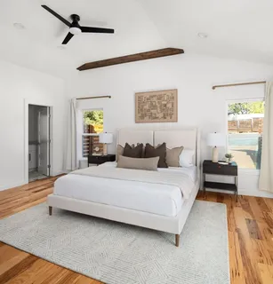 a bedroom with a bed couch and window