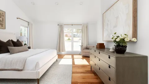a bedroom with a bed and a potted plant