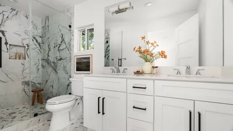 a bathroom with a toilet sink and mirror