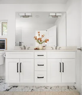 a bathroom with a sink vanity and mirror
