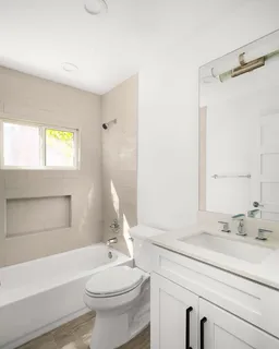 a bathroom with a sink a toilet and a bathtub