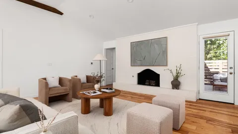 a living room with furniture a fireplace and a table