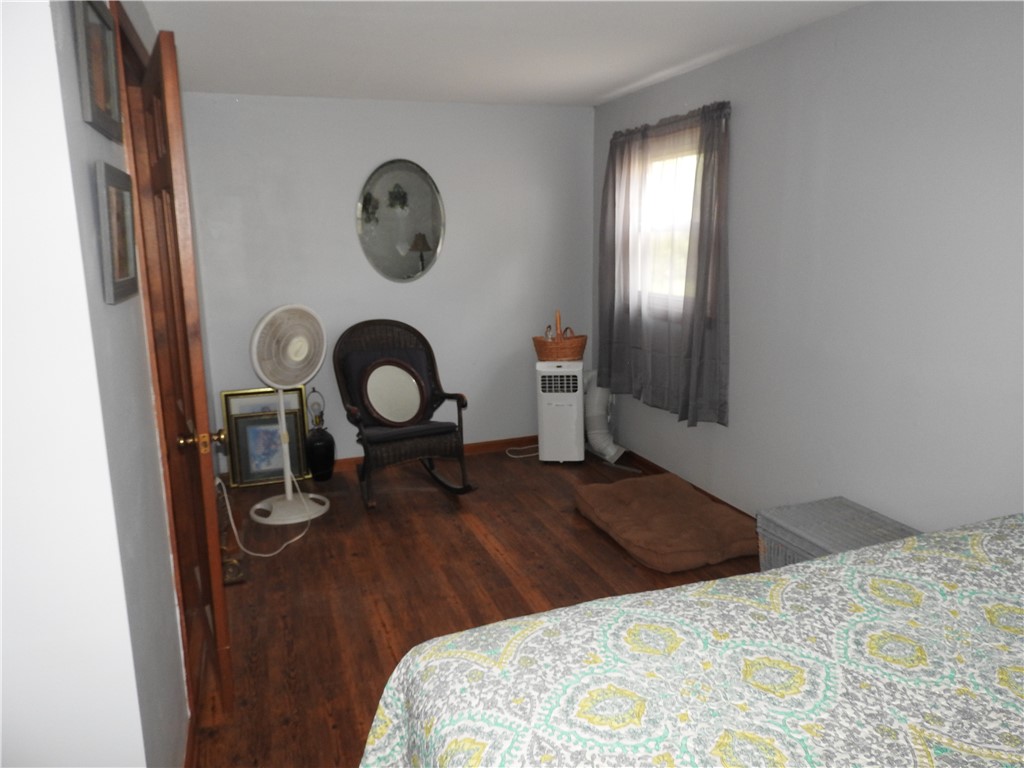 2185 East Loy Road Piqua, OH 45356 - Photo 16 of 19 This serene bedroom offers a comfortable retreat with warm wood flooring and ample natural light.