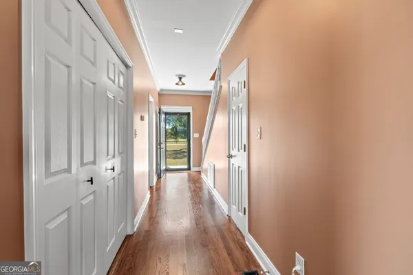 a view of a hallway with wooden floor