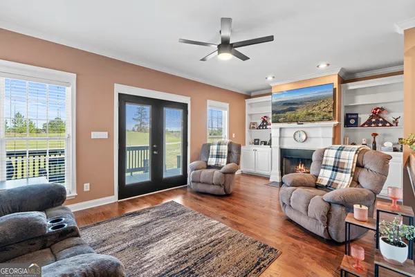 a living room with furniture fireplace and a large window