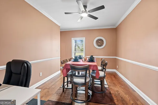 a view of a dining room with furniture and wooden floor