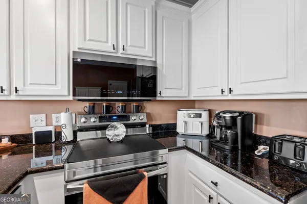 a kitchen with appliances cabinets and a counter top space