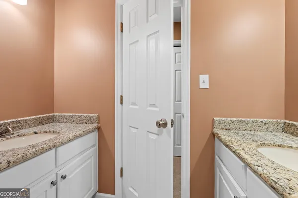a bathroom with a granite countertop sink and vanity