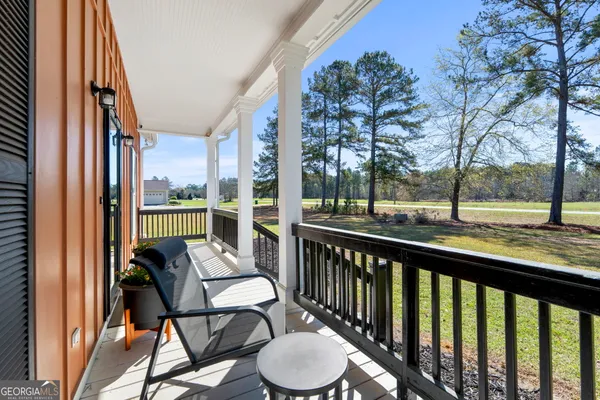 a view of a chair and tables in the balcony