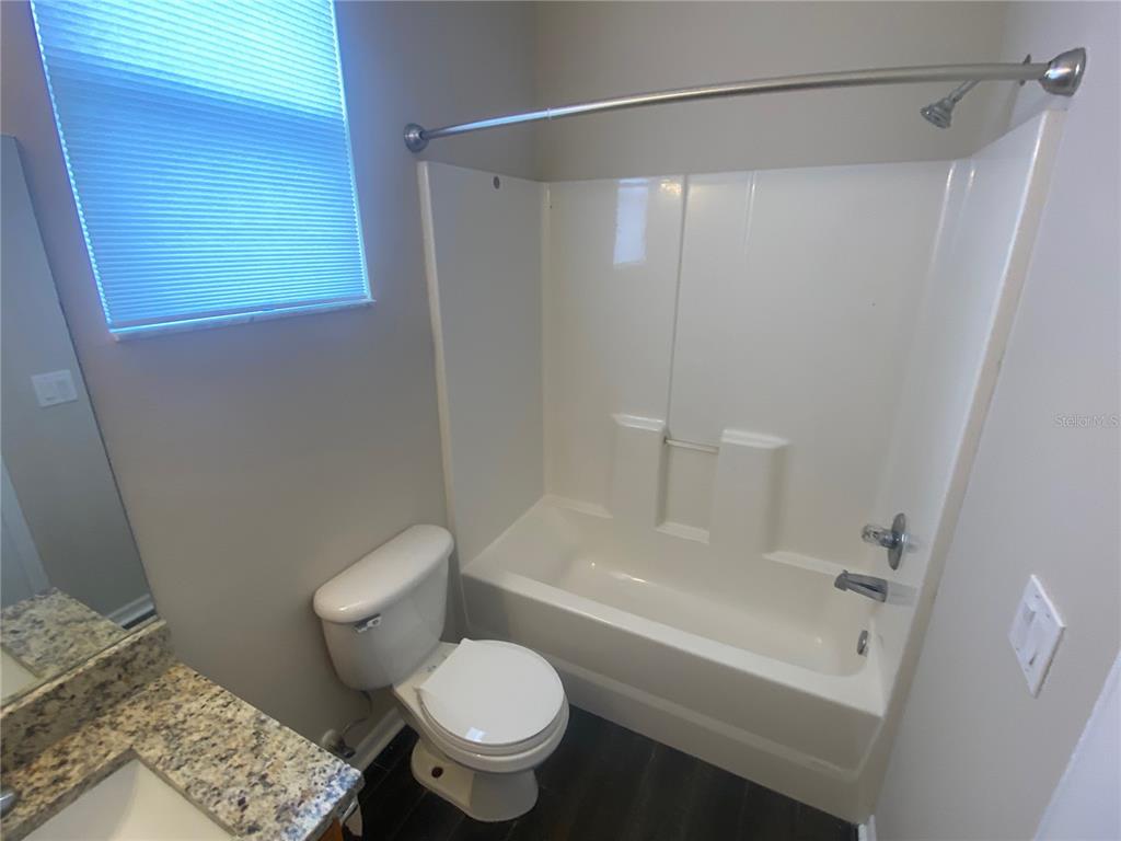 2409 Spring Hollow Loop Wesley Chapel, FL 33544 - Photo 12 of 47 a bathroom with a shower a toilet and a sink