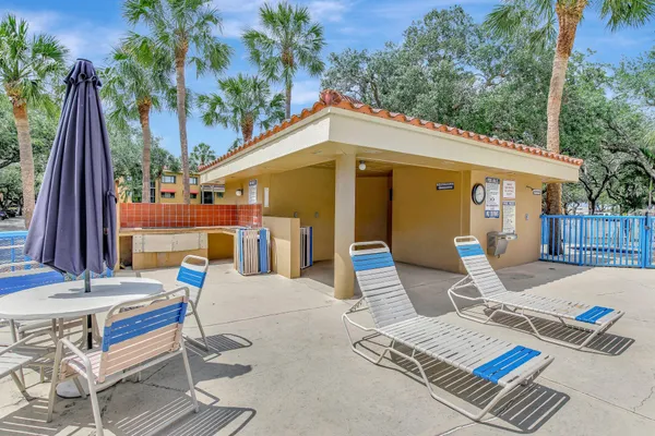 a view of a patio with a table and chairs