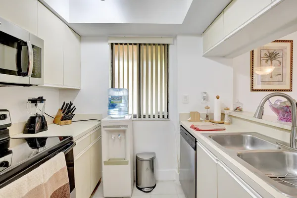 a view of a kitchen sink and a window