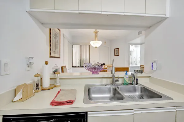 a kitchen with sink and a mirror
