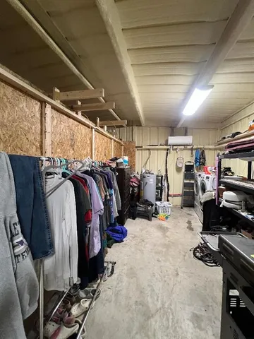 a view of walk in closet with clothes and shoes