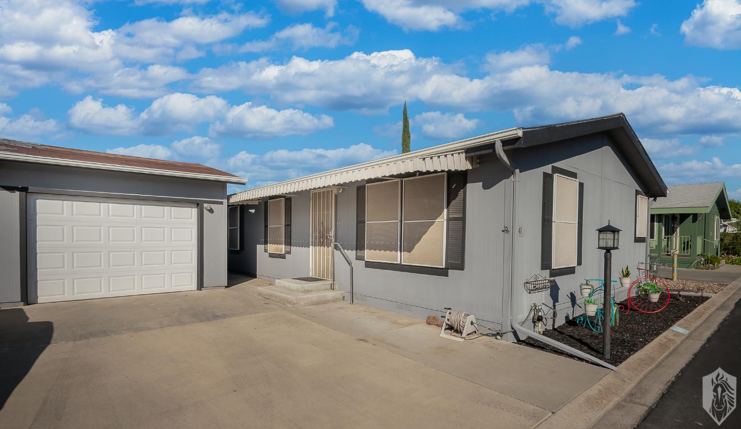 a view of a house with a backyard