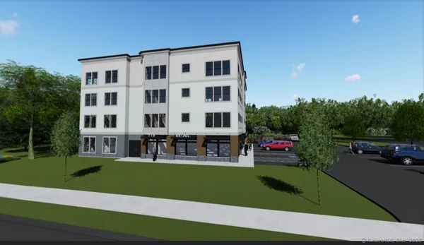 a view of building with lot of cars and trees