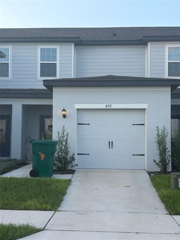 872 Poppy Lane Dundee, FL 33838 - Photo 1 of 13 front view of a house with a garden