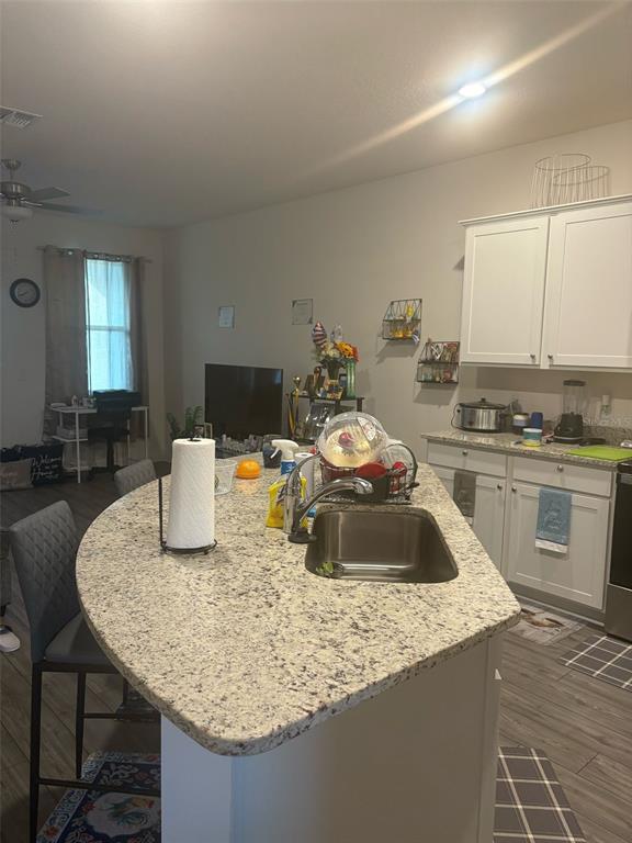 872 Poppy Lane Dundee, FL 33838 - Photo 4 of 13 a kitchen with granite countertop a sink a stove and cabinets