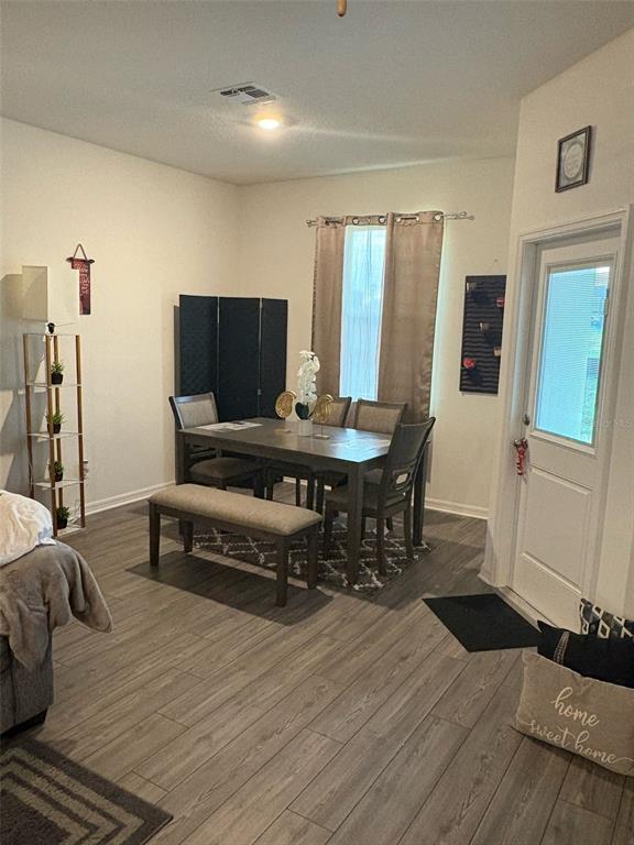 872 Poppy Lane Dundee, FL 33838 - Photo 6 of 13 a living room with furniture and wooden floor