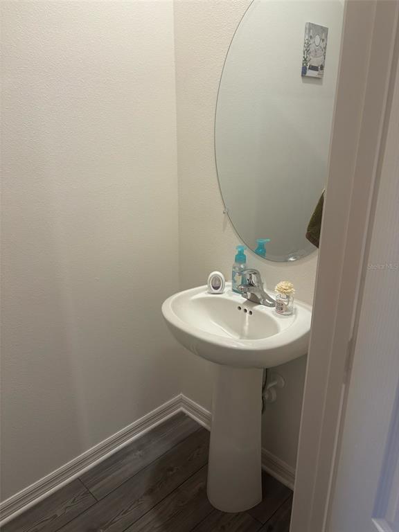 872 Poppy Lane Dundee, FL 33838 - Photo 7 of 13 a bathroom with a sink and mirror