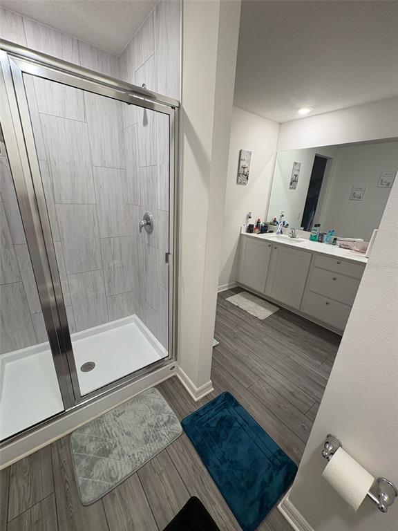 872 Poppy Lane Dundee, FL 33838 - Photo 9 of 13 a room with a bed and a glass door shower