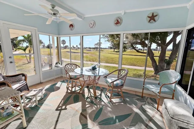 a living room with furniture and a floor to ceiling window