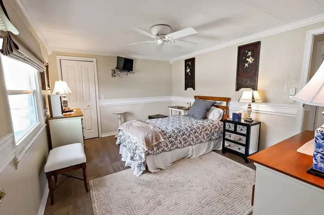 a bedroom with a bed a couch and dresser