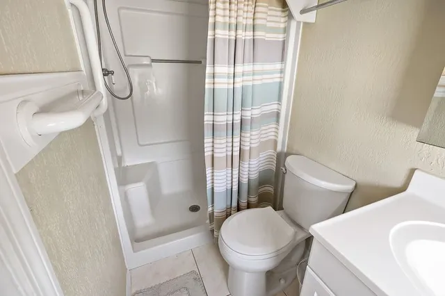 a bathroom with a toilet and shower