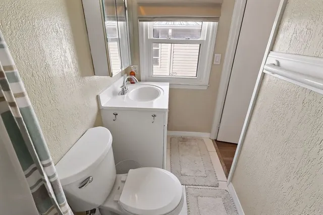 a white toilet sitting next to a bathroom sink