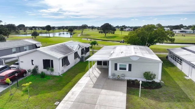 an aerial view of a house with swimming pool garden and lake view