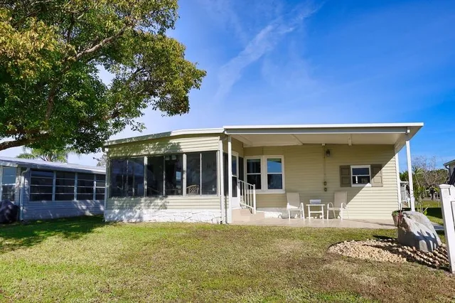 a view of a house with swimming pool and porch with furniture