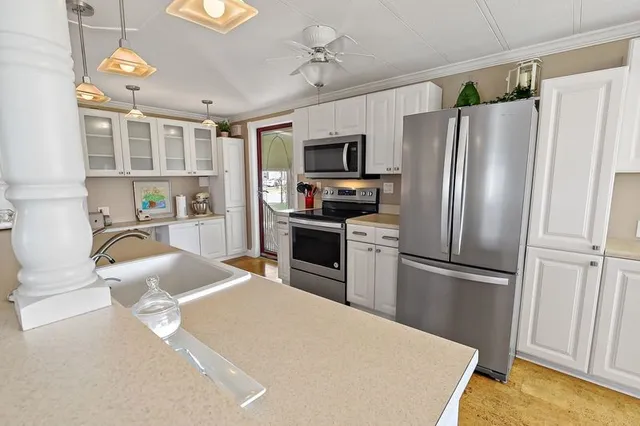 a kitchen with stainless steel appliances a refrigerator sink and microwave