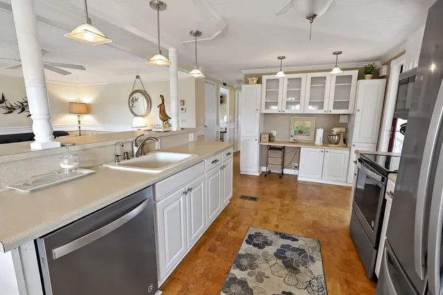 a large kitchen with kitchen island a sink stove and refrigerator