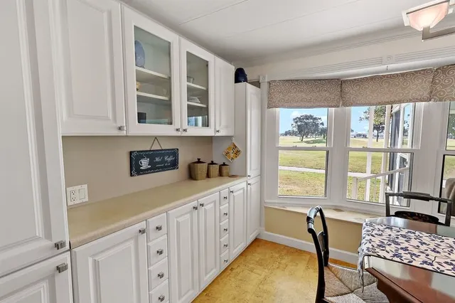a kitchen with a window a sink and a cabinets