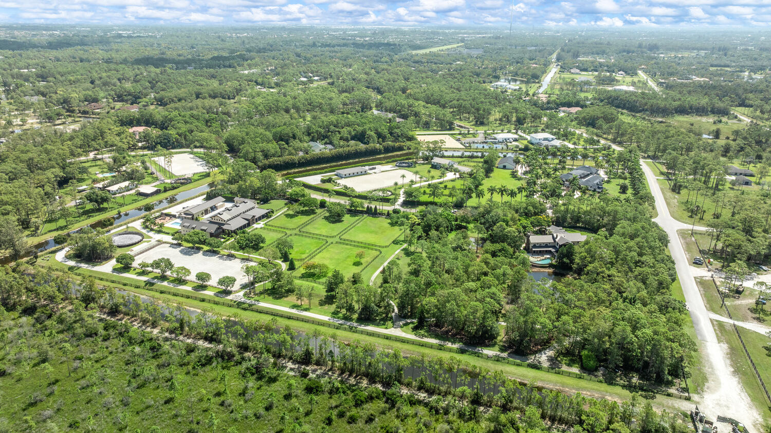 6259 Homeland Road Lake Worth, FL 33449 - Photo 2 of 62 a view of a big yard with plants and large trees